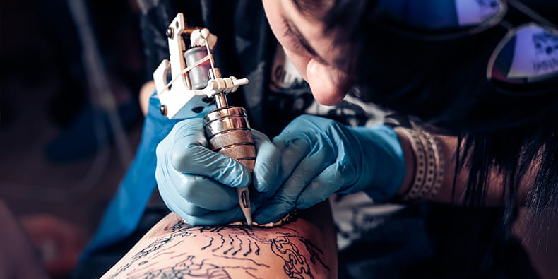 Tattoo Artist Applying Ink to the Skin