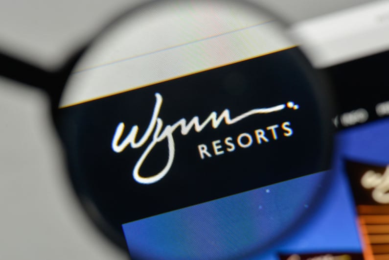 Wynn Resorts logo under a magnifying glass