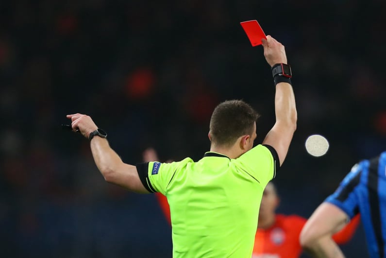 Soccer referee issuing red card