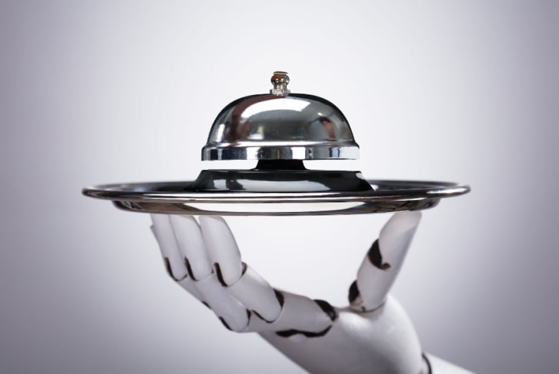 Bell on silver platter held by robot hand