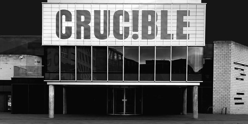 Large Building With A Sign That Reads "Crucible"